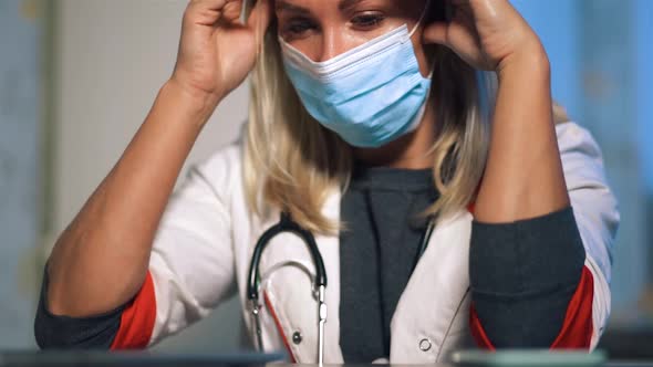 Female Doctor in Surgical Mask Sitting in Depression
