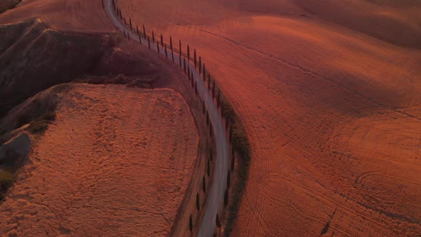 Aerial shot of a biker traveling in Val d'orcia ,TUSCANY,ITALY