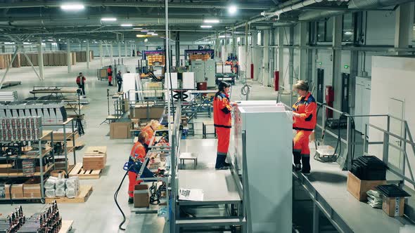 Fast Motion of Factory Technicians Assembling Refrigerators