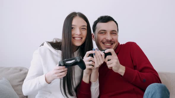 A Pretty Girl and a Boy Are Playing Video Games in the Living Room