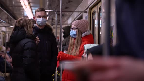 Group of Masked People in Underground Carriage