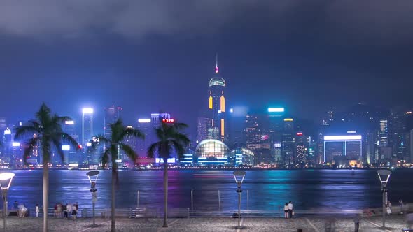 Hong Kong City Skyline at Night Over Victoria Harbor with Clear Sky and Urban Skyscrapers Timelapse