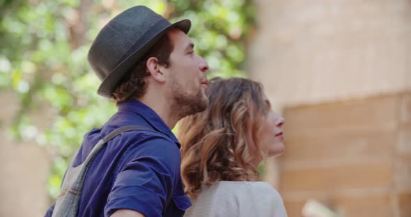 Man and Woman Smiling and Looking Outside in Town or city.Two Tourists Looking Around During City