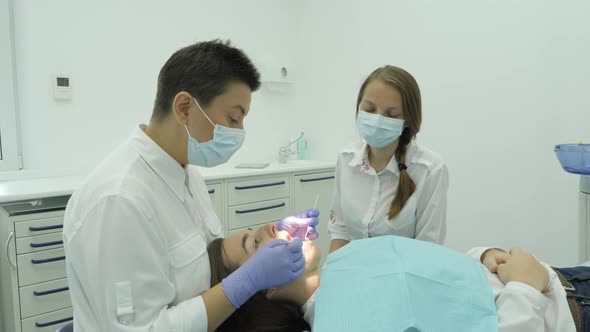 Dentist and nurse treating a patient