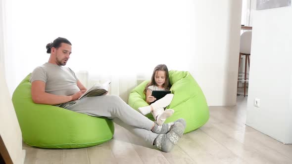 Close Up of Cheerful Teen Girl with Long Hair is Hugging Her Dad and Laughing in the Living Room at