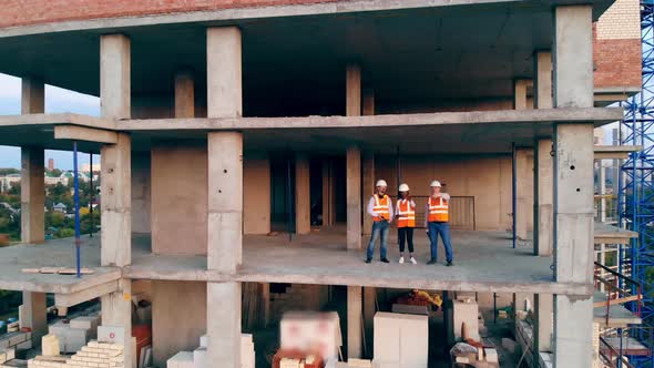 Architects Are Planning a Project While Standing in a Building House alt