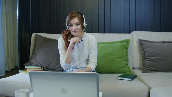 Young Smiling Laughing Lady Student Wearing Headphones Communicating By Video Call
