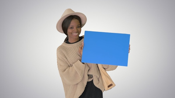 Attractive young african american female showing and pointing