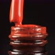Red Gel Nail Polish with an Open Bottle and a Drop Dripping Into a Jar with a Brush in the Beauty - VideoHive Item for Sale