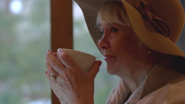 Elderly Woman Drinking From Cup