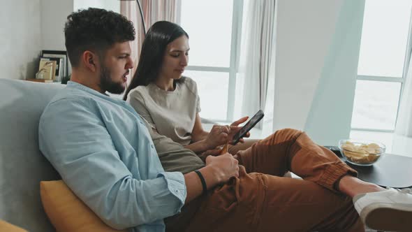 Young Latin Couple Ordering Food Via Delivery Service