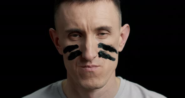 A man with military paint on his face. Declaration of war.