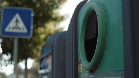 Young Man Male Hand Dropping Glass Plastic Bottle Into Recycle Bin and There are Waste Separation