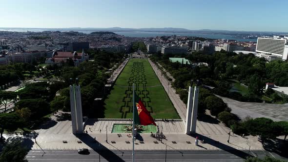 Aerial View of Portugal Flag Waving in the Wind on Eduardo VII Park Lisbon