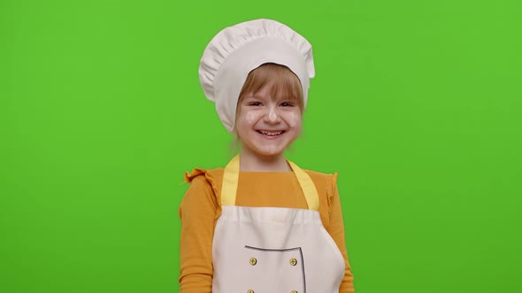 Charming Child Girl Dressed Like Chef Cook Laughing Out Loud After Hearing Ridiculous Anecdote