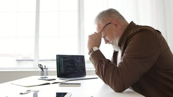 man works in an office at a table