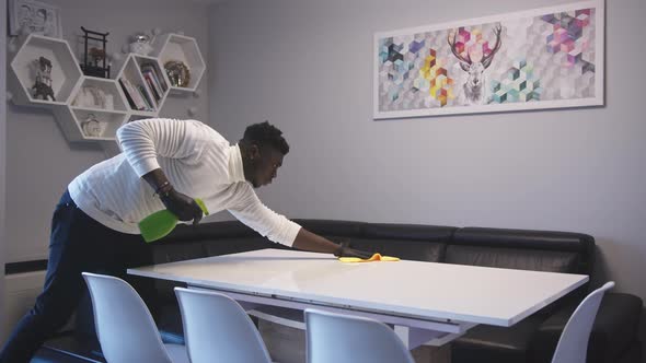 Young Happy African American Black Man Wiping the Dinning Table