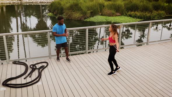 Aerial shot of a woman working out with a trainer in the park