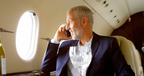 Businessman Talking on Mobile Phone While Travelling in Private Jet 4k