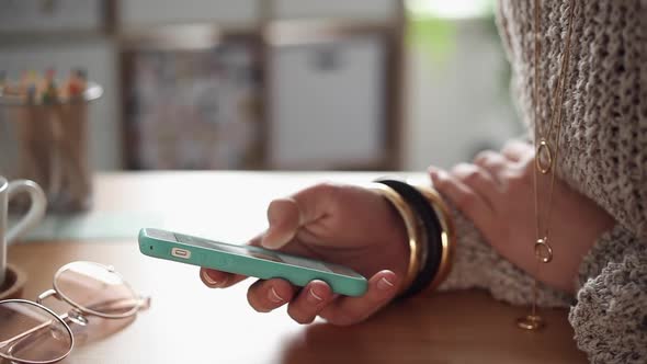 Young Woman Scrolling her Smartphone