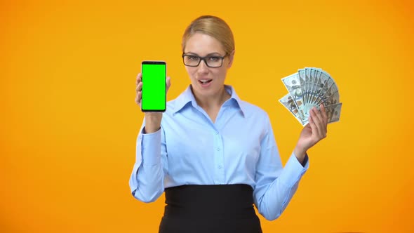 Pretty Caucasian Lady Showing Green Screen Smartphone and Dollars, Cash Back