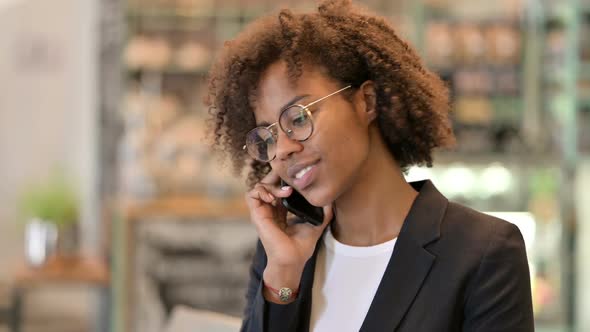 Cheerful African Businesswoman Talking on Smartphone