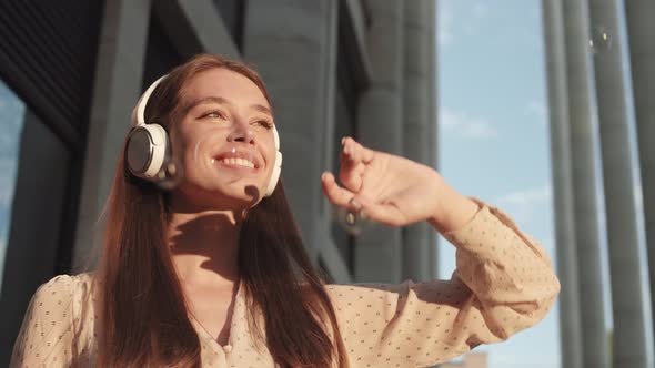 Woman with Earphones and Soap Bubbles