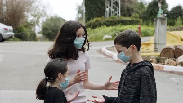 Coronavirus pandemic - kids walking outdoors with face masks to avoid corona