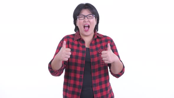 Happy Overweight Asian Hipster Woman Giving Thumbs Up and Looking Excited