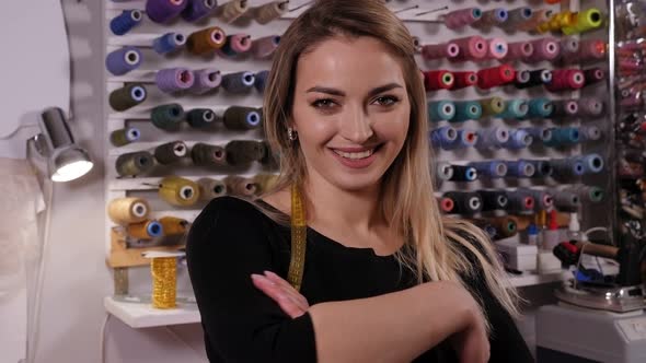 Portrait of a Young Woman Dressmaker in a Professional Atelier