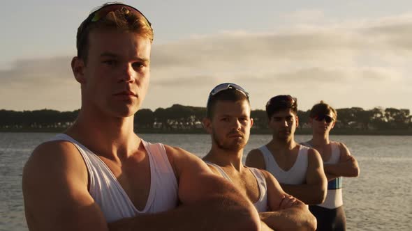 Male rower team looking at camera with arms crossed
