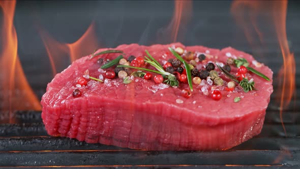 Super Slow Motion Shot of Fresh Beef Meat and Seasoning on Grill at 1000 Fps