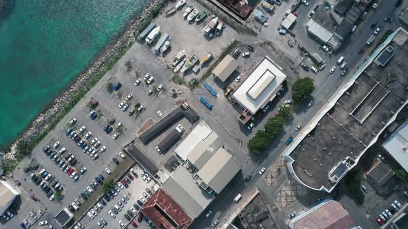 Top-down view of the rooftops, cars, sea, the pier and many yachts in Bridgetown, Barbados