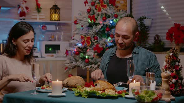 Couple Eating Festive Meal at Christmas Eve Dinner