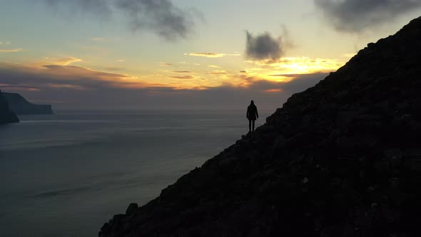 Drone Over Man On Mount Villingadalsfjall Watching Sunset