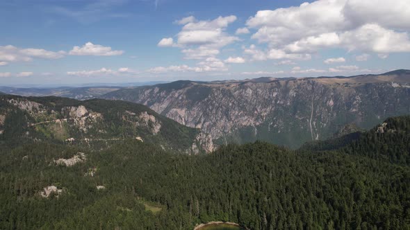 Aerial view of mountain lake surrounded by dense forest. Montenegro, Europe