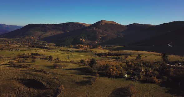 aerial view of beautiful green meadow close to ranch in the middle of nowhere