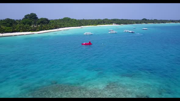 Aerial top down landscape of marine lagoon beach time by turquoise water with white sandy background