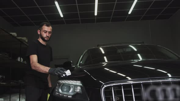 Professional Car Ceramics Worker Applies a Layer of Ceramics Protective Rain