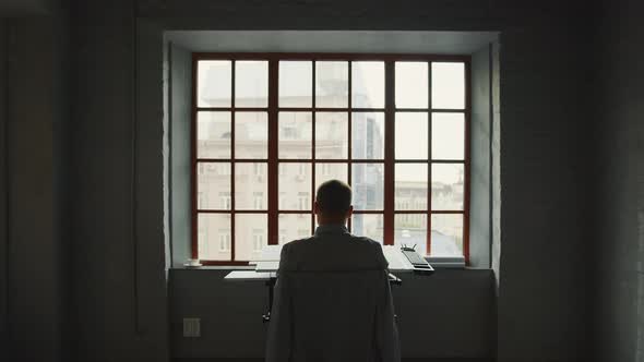 Young architect relaxing by the window