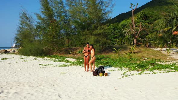 Women tan on marine sea view beach voyage by turquoise sea with clean sand background of Koh Phangan