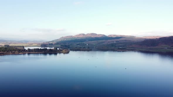 Scottish lake with Ben Lomond mountain in background. Aerial drone panoramic view