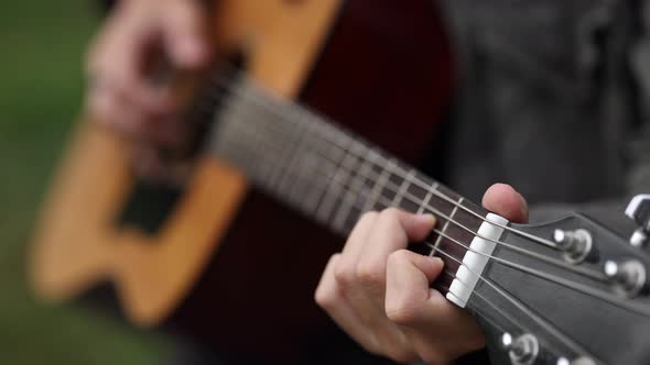 Closeup of Teenage Boy Playing Guitar