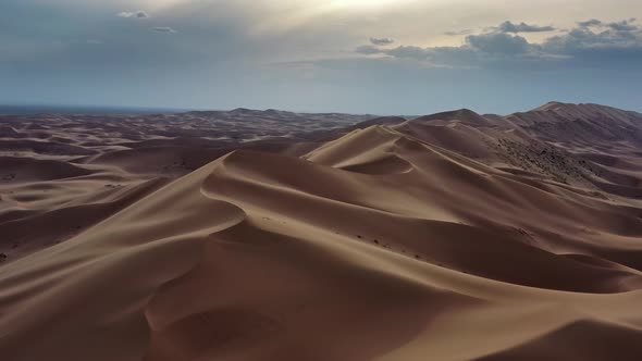 Aerial View of Sand Dunes in Desert at Sunset