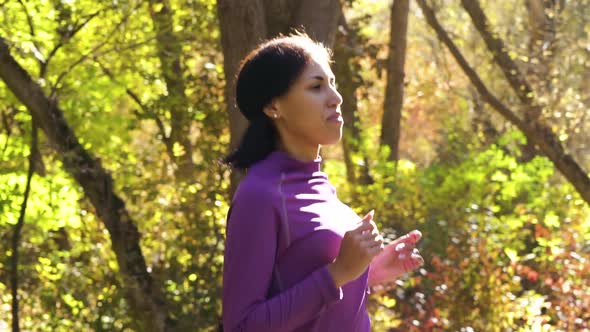 Black Female Jogger in Autumn Park