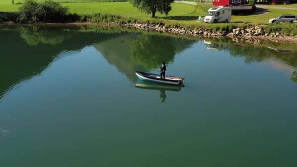 Woman on the Boat Catches a Fish on Spinning in Norway