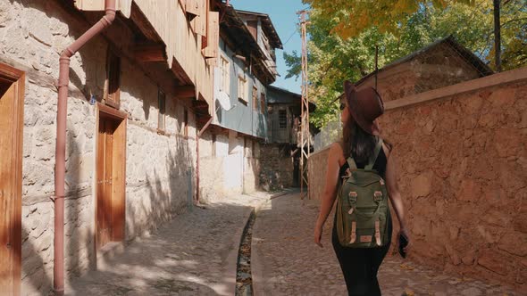 Woman Walking on Historical Street