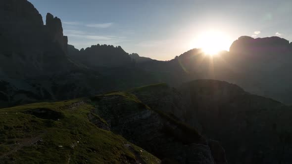 Female and male hikers at the top of the mountain at sunrise.