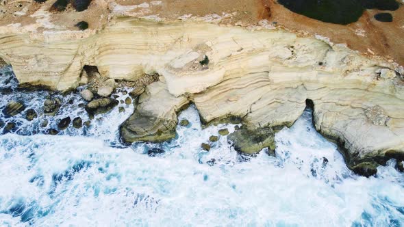 Pure Blue Ocean Water Waves with Light Reflections Crush Mountain at Beautiful Coastline Slow Motion