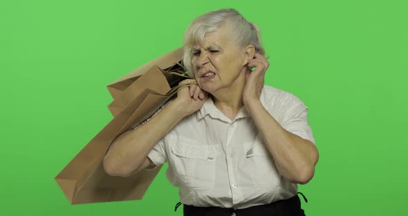 An Elderly Bored Woman with Shopping Bags. Shopping. Presents. Chroma Key